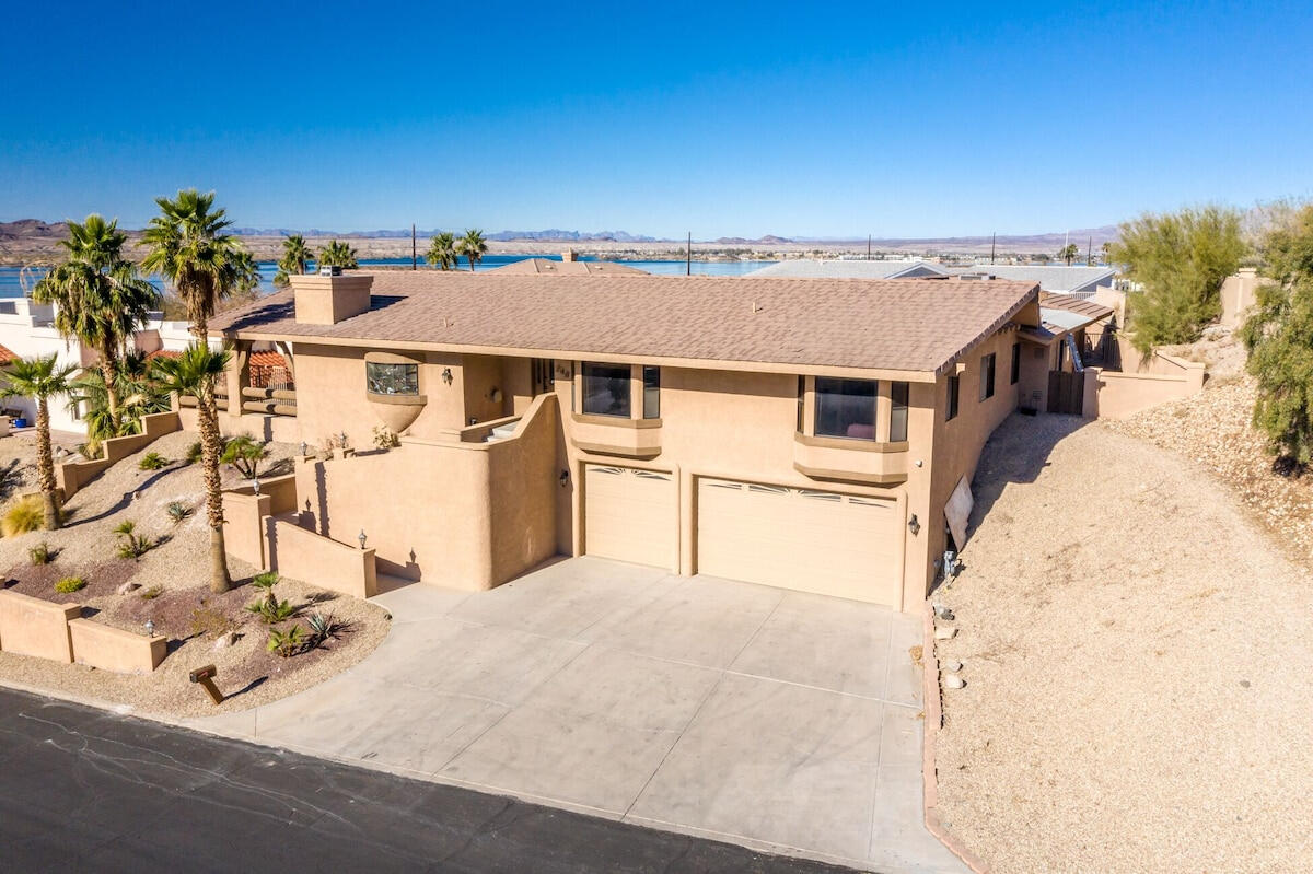 Lakeview Lodge Exterior with Garage and Lake Havasu Views Front exterior of Lakeview Lodge vacation rental in Lake Havasu City Arizona with three car garage, desert landscaping and views of Lake Havasu